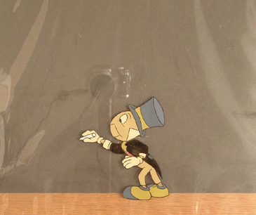 Small cel of Jiminy Cricket writing on a blackboard with chalk