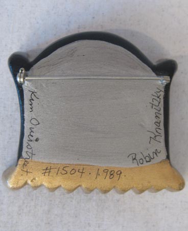 Back of brooch showing signature