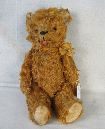 11 inch silk/rayon blend bear with gold ribbon, sticking out tongue