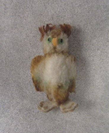 very small brown and tan owl