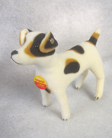 White velveteen dog with black and brown spots
