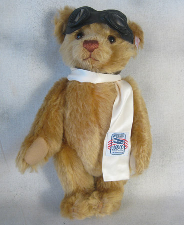 Tan teddy bear wearing an aviator cap, goggles, and scarf with Wright Brothers embroidery