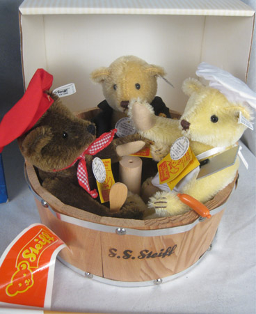 Three small bears in wooden tub with accessories