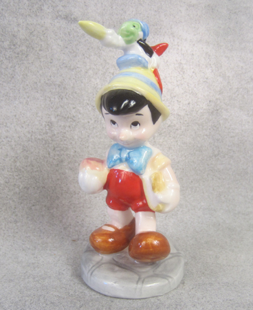 Ceramic Pinocchio with Jiminy Cricket on his head