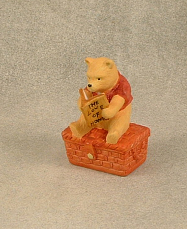 Ceramic figure of Winnie the Pooh on basket