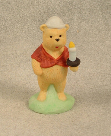 Ceramic figure of Winnie the Pooh with candle