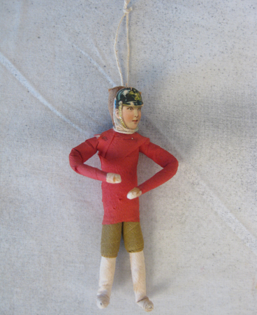 Spun cotton soldier in red and green crepe paper outfit