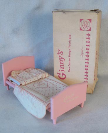Ginny's pink wooden bed with box and bedding