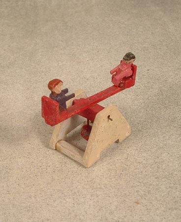 Wooden seesaw with children playing